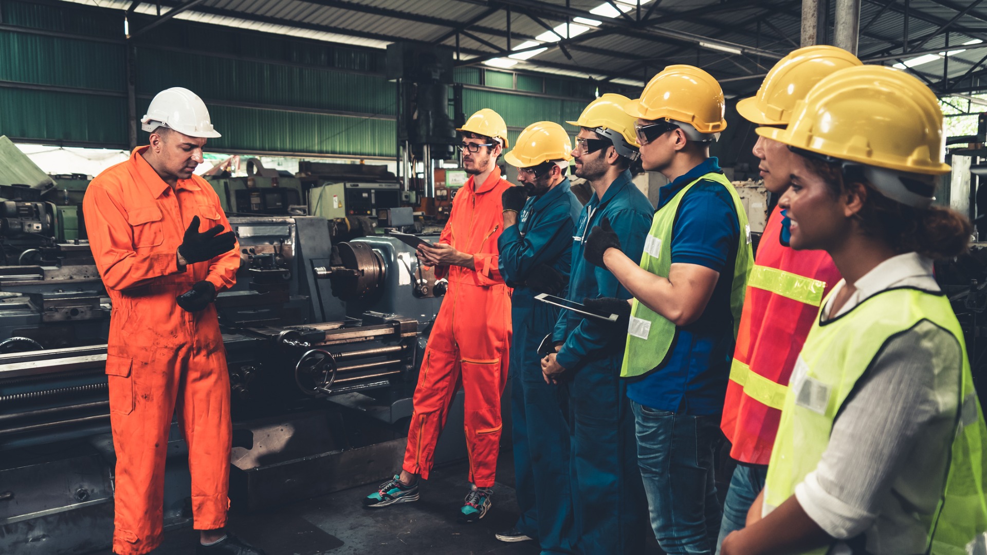 skillful-worker-attending-brief-meeting-in-the-factory-picture-id1302718747